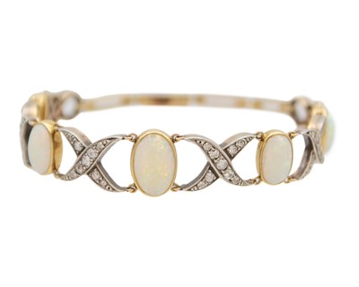 Lot 77 - An early 20th century white precious opal and diamond set gold bracelet, within J.W. Benson Ltd box.