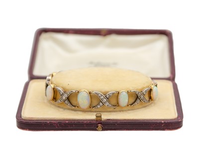 Lot 77 - An early 20th century white precious opal and diamond set gold bracelet, within J.W. Benson Ltd box.