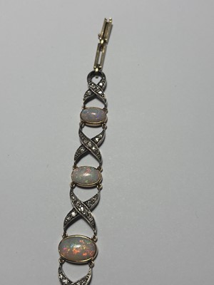 Lot 77 - An early 20th century white precious opal and diamond set gold bracelet, within J.W. Benson Ltd box.