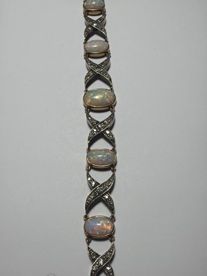 Lot 77 - An early 20th century white precious opal and diamond set gold bracelet, within J.W. Benson Ltd box.
