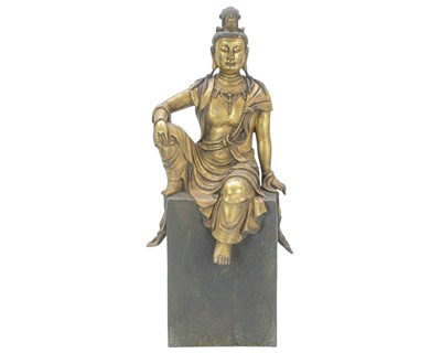 Lot 438 - A Chinese bronze and gilded figure of Guanyin.