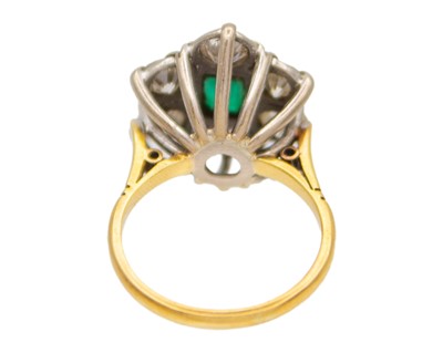 Lot 83 - A good emerald and diamond set 18k and platinum cluster ring.