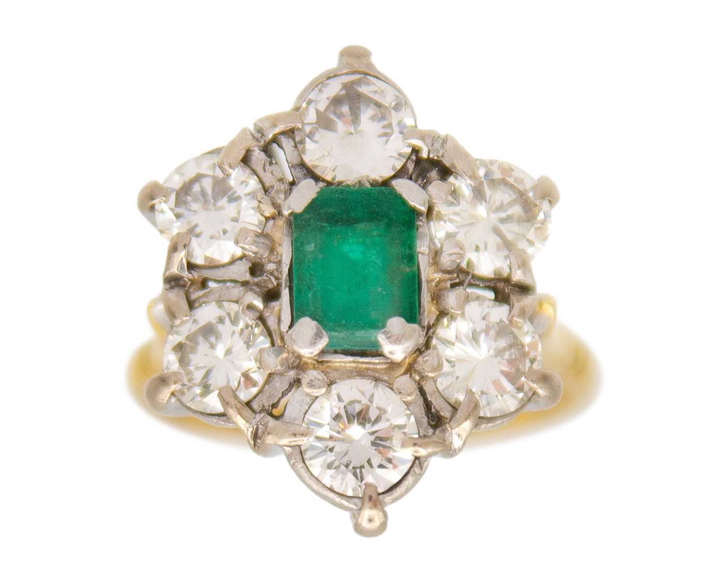 Lot 83 - A good emerald and diamond set 18k and platinum cluster ring.