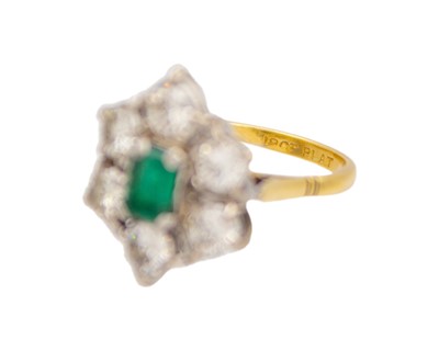 Lot 83 - A good emerald and diamond set 18k and platinum cluster ring.