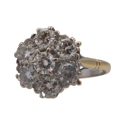 Lot 163 - An attractive and vibrant diamond set 18k daisy cluster ring.