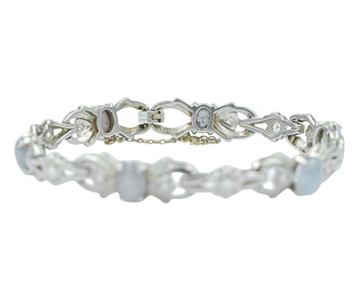 Lot 82 - An attractive platinum diamond and moonstone set bracelet.