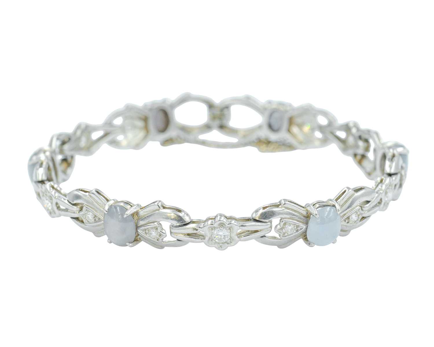 Lot 82 - An attractive platinum diamond and moonstone set bracelet.