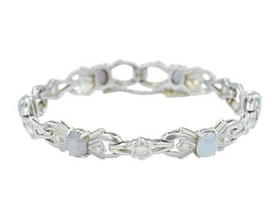 Lot 82 - An attractive platinum diamond and moonstone set bracelet.