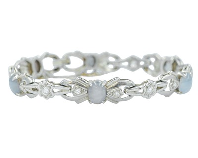 Lot 82 - An attractive platinum diamond and moonstone set bracelet.