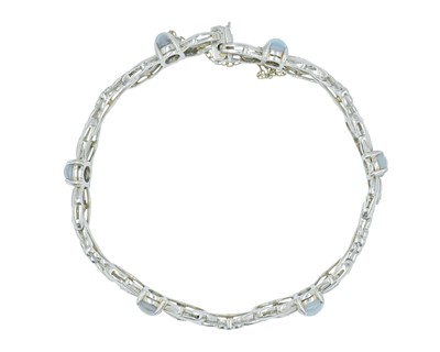 Lot 82 - An attractive platinum diamond and moonstone set bracelet.