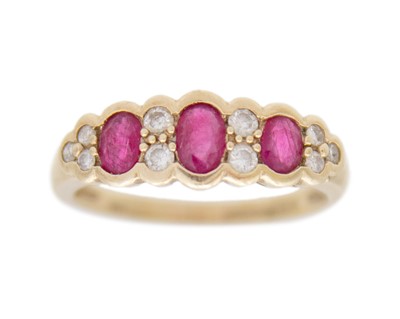 Lot 120 - A modern 9k gold ruby and diamond set ring.