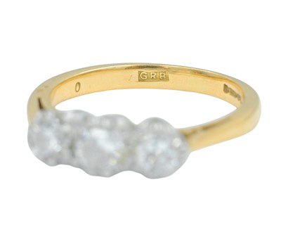 Lot 79 - An 18k gold three-stone diamond ring.