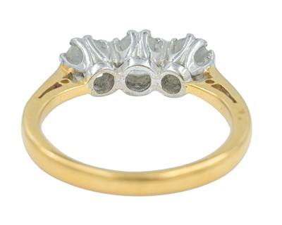 Lot 79 - An 18k gold three-stone diamond ring.