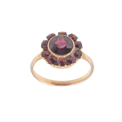 Lot 132 - A dainty garnet cluster ring set in gold.