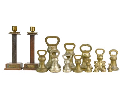 Lot 3 - A pair of teak and brass candlesticks.