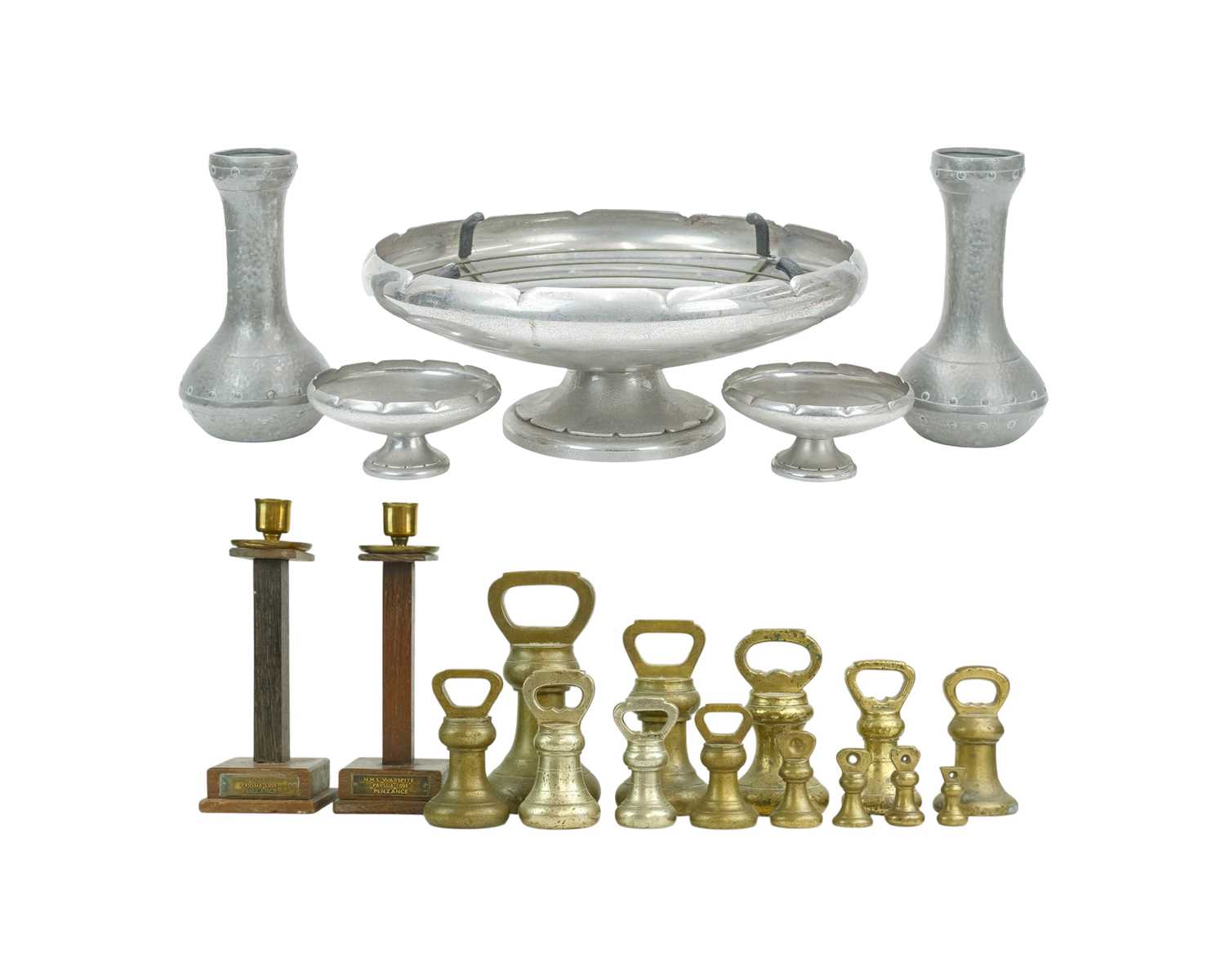 Lot 3 - A pair of teak and brass candlesticks.