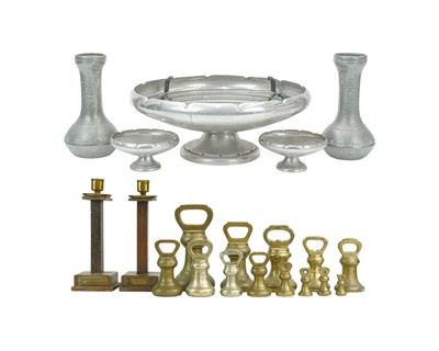 Lot 3 - A pair of teak and brass candlesticks.