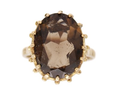 Lot 213 - A 9k hallmarked gold smokey quartz set cocktail ring.