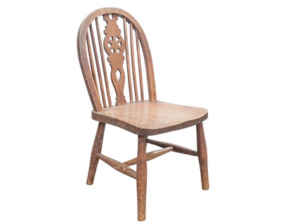 Lot 889 - A Child's beech and elm wheelback Windsor chair.