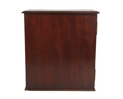 Lot 58 - A late George III mahogany apothecary cabinet.