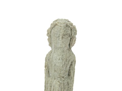 Lot 106 - A small carved stone figure of a deity.