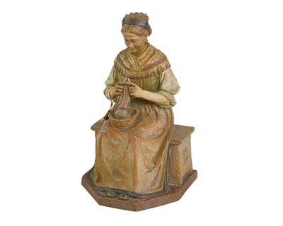 Lot 72 - A carved and painted pine figure of a lady knitting.