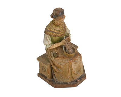 Lot 72 - A carved and painted pine figure of a lady knitting.