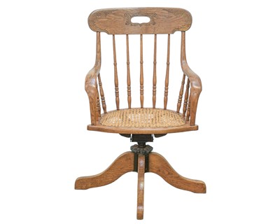 Lot 843 - An American ash swivel office chair.