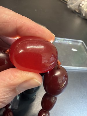 Lot 85 - A bakelite cherry amber style graduated oval bead necklace.