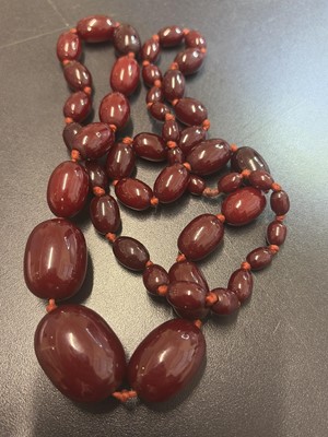 Lot 85 - A bakelite cherry amber style graduated oval bead necklace.