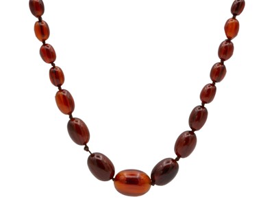 Lot 172 - A cognac amber graduated oval bead necklace.