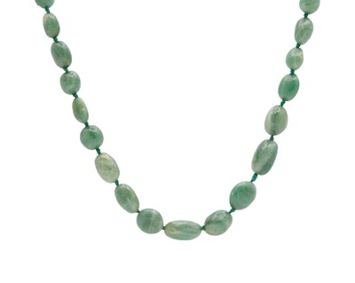 Lot 201 - A green jadeite graduated bead necklace.