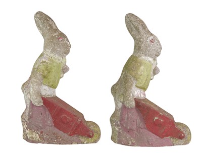 Lot 825 - A pair of reconstituted stone figures of rabbits with wheelbarrows.