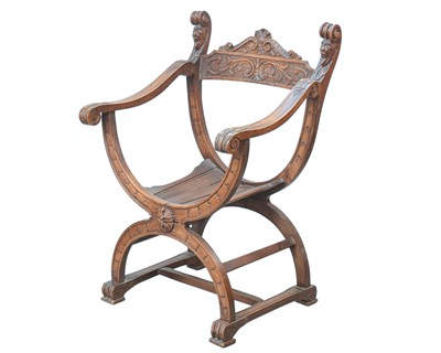 Lot 865 - A walnut Savonarola chair.