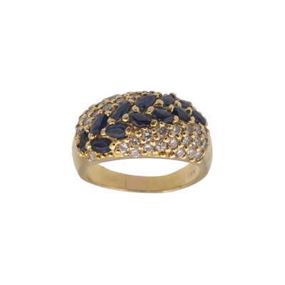Lot 165 - An 18k diamond and sapphire pavé set bombé ring.