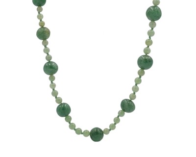 Lot 203 - A green jadeite bead necklace.