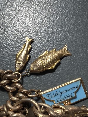Lot 158 - A good 9k charm bracelet applied with 10 gold charms and a turquoise set padlock clasp.