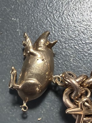 Lot 158 - A good 9k charm bracelet applied with 10 gold charms and a turquoise set padlock clasp.