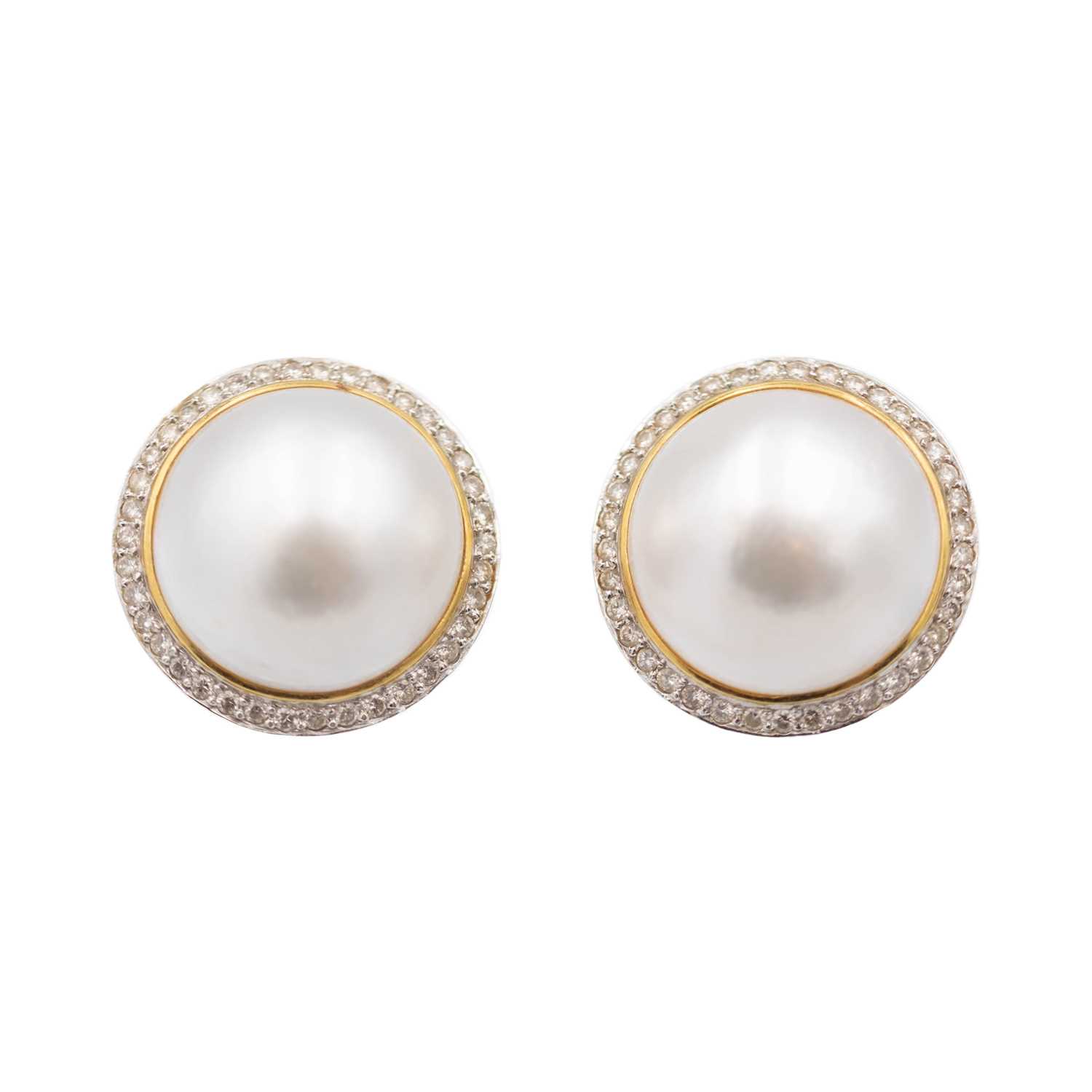 Lot 121 - A good pair of large mabe pearl and diamond set 14k white and yellow gold clip earrings.