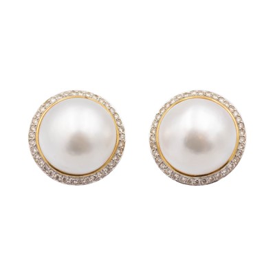 Lot 121 - A good pair of large mabe pearl and diamond set 14k white and yellow gold clip earrings.