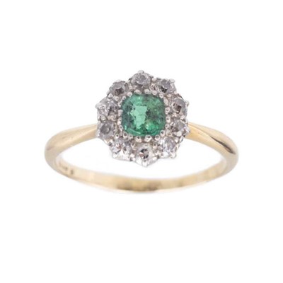 Lot 128 - An attractive early 20th-century emerald and diamond cluster ring, set in 18k gold.