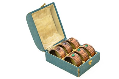 Lot 733 - A set of six Arts and Crafts copper napkin rings, cased.
