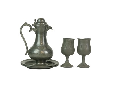 Lot 75 - A 19th century pewter communion set.
