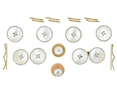 Lot 309 - MAPPIN & WEBB - A 9k and platinum mother-of-pearl shirt dress set, within original box.