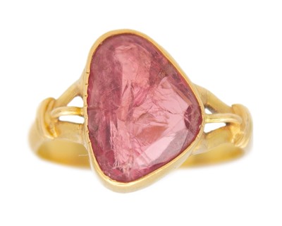 Lot 289 - A high-purity gold ring, set with an irregular-cut pink sapphire.