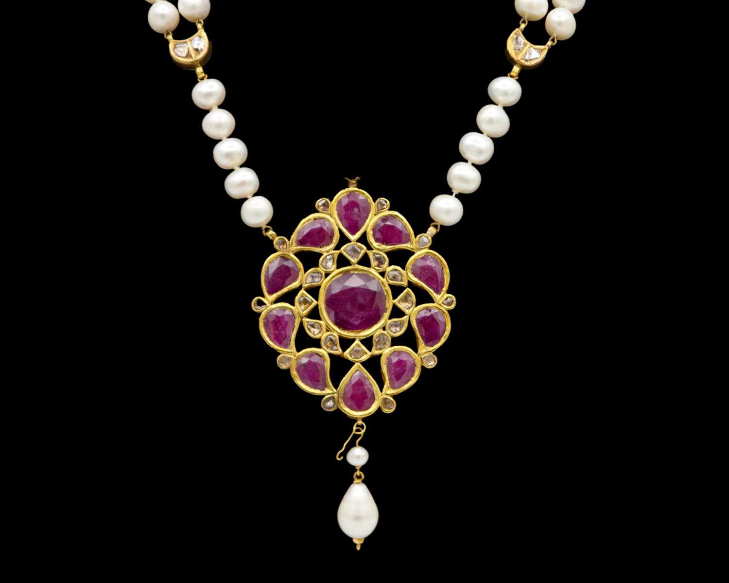 Lot 286 - A traditional Indian high-purity gold, diamond and ruby kundan-set pendant, on a pearl necklace.