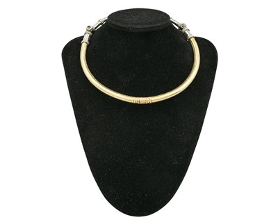 Lot 312 - An Indian Rajasthan Hasli silver and gold-plated neck torque.