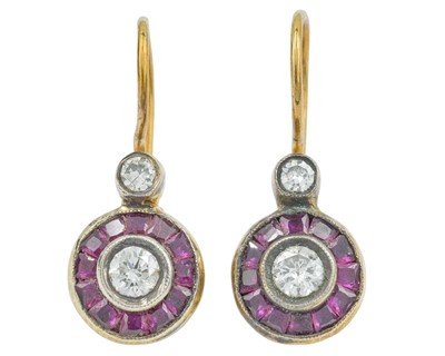 Lot 164 - A pair of 8k rose gold diamond and ruby target style earrings.