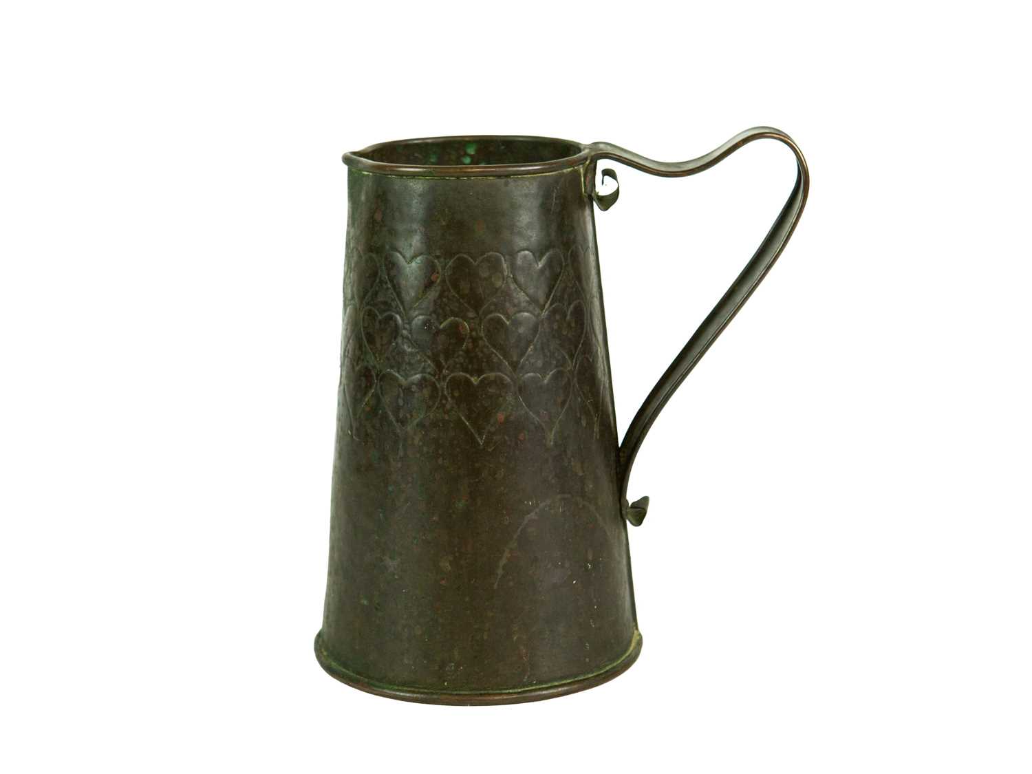 Lot 38 - An Arts and Crafts copper ale jug with repousse heart decoration.