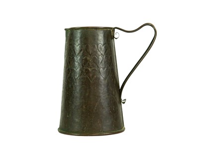 Lot 38 - An Arts and Crafts copper ale jug with repousse heart decoration.